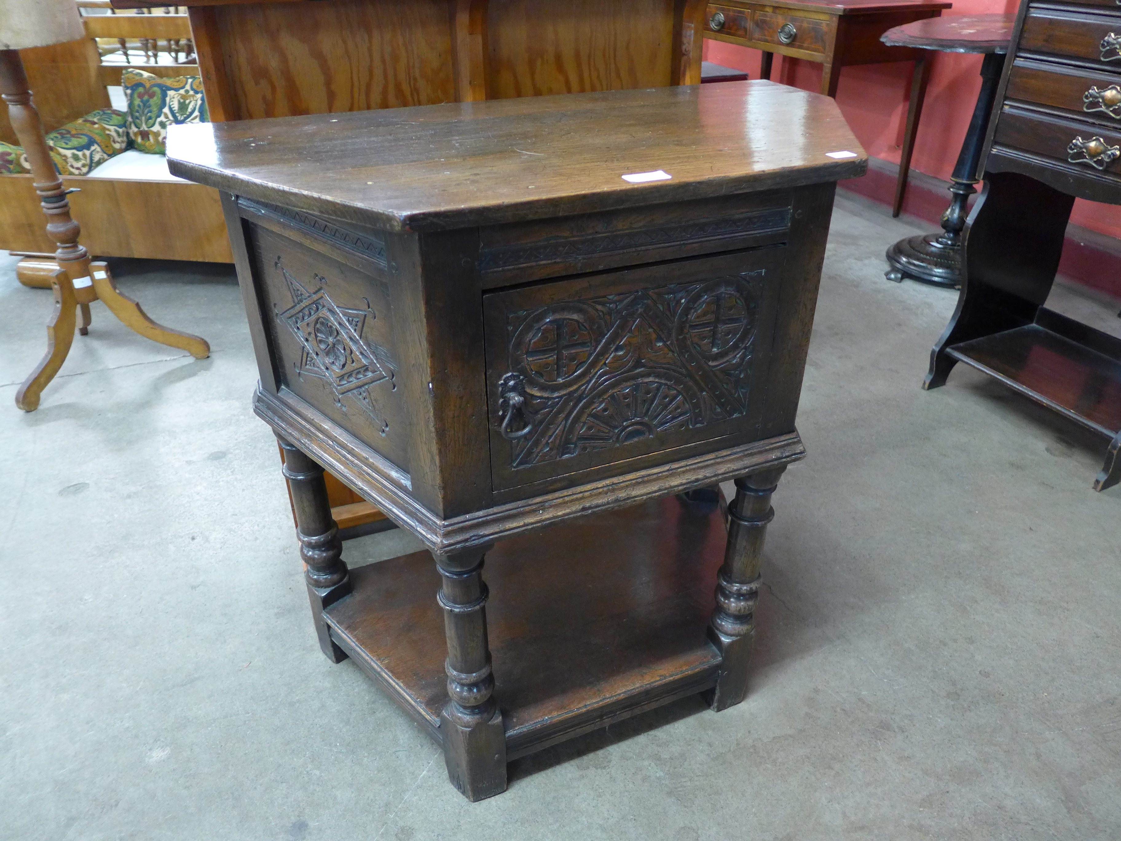 A 17th Century style carved oak credence cupboard