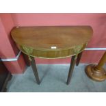 A George III mahogany and parcel gilt demi-lune side table