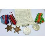 Four WWII medals with ribbons,
