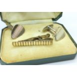 A pair of 9ct gold on silver cufflinks and a tie pin