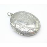 A silver locket marked STG,