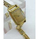 A lady's 14kt gold Omega wristwatch on a rolled gold strap