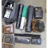 A pair of early 20th Century field glasses, cameras, camera lens, etc.