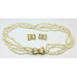 A freshwater pearl necklace with a 14kt gold clasp and a pair of earrings,