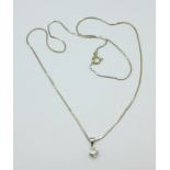 A white metal chain marked 750 and a diamond set pendant, total weight 3.