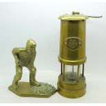 A brass miner's lamp and a brass figure of a miner
