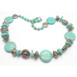 A large turquoise necklace