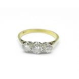 An 18ct gold, three stone diamond ring, 2.