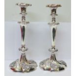 A pair of plated candlesticks,