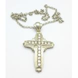 A large silver cross pendant on a silver belcher chain,