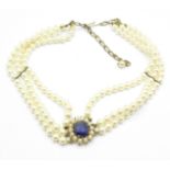 A silver gilt and blue stone set pearl collarette