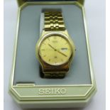 A gentleman's Seiko quartz day date wristwatch with guarantee and instructions, boxed,