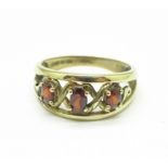 A 9ct gold, three stone garnet ring, 2.