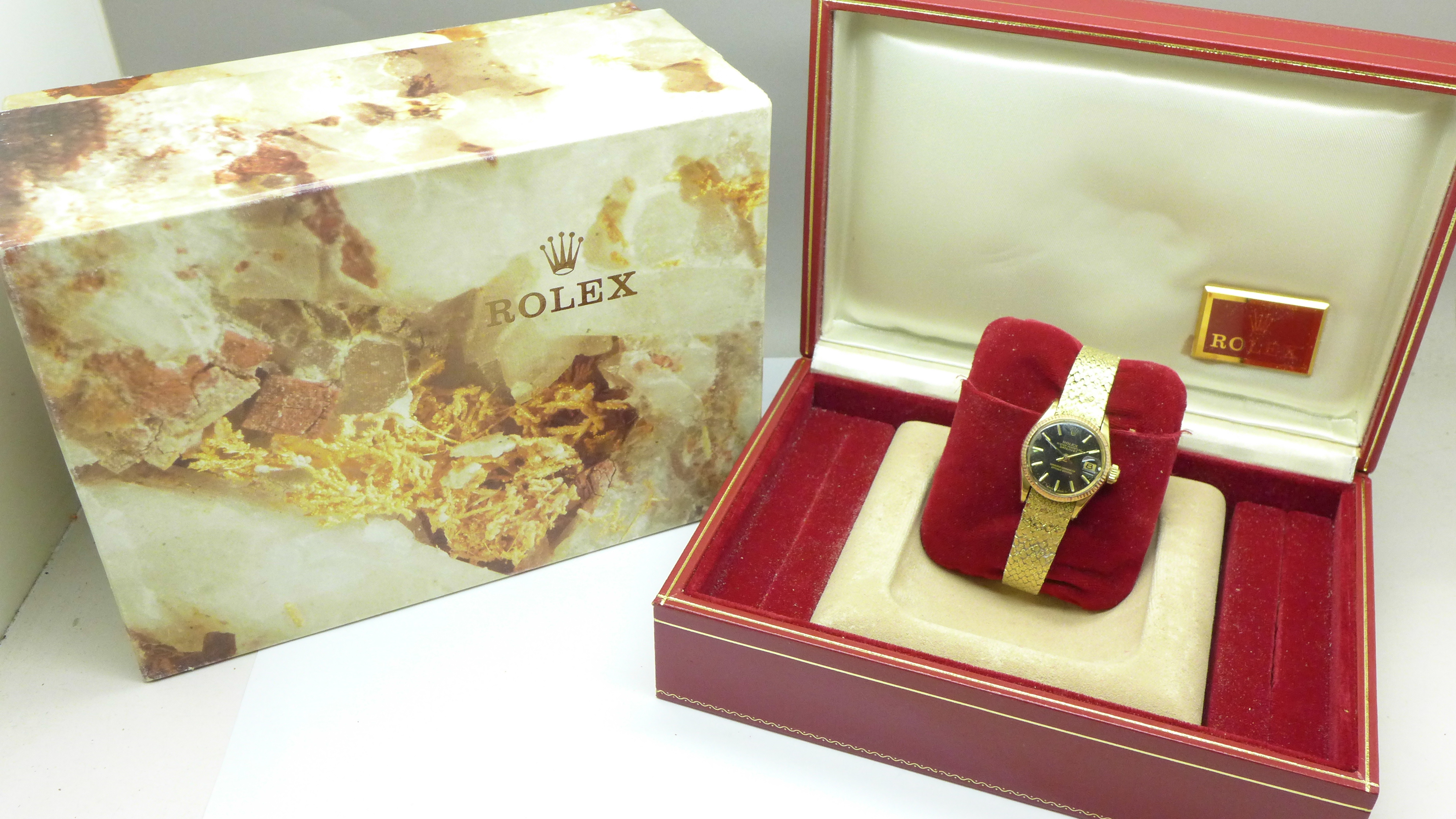 A lady's 18ct gold cased Rolex Oyster Perpetual Datejust wristwatch on an 18ct gold Rolex bracelet