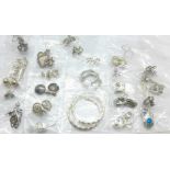 Twenty-five pairs of silver earrings