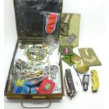 A WWII German military tin with reproduction medals, knife, badges, etc.