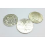 Three uncirculated silver coins including a 1922 peace dollar