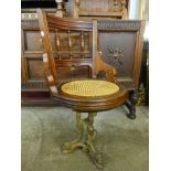 A Victorian beech ship's chair on cast iron base