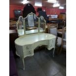 A French style cream and parcel gilt kidney shaped dressing table