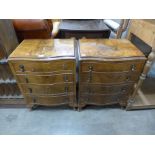 A pair of small walnut serpentine chests of drawers