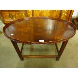 A mahogany oval tray top coffee table