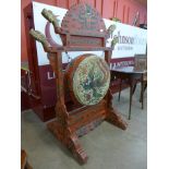 A Chinese red chinoiserie lacquered drum on stand