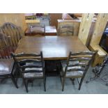 An oak refectory table and four ladderback dining chairs