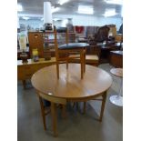 A teak extending dining table and four chairs