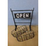 A pair of metal planters and a steel open sign