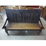 A George III carved oak settle