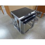 An Italian style chrome and black glass nest of tables