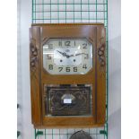 A French Art Deco oak wall clock