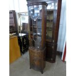 A slim mahogany bow front bookcase