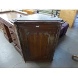 A George III oak hanging corner cupboard