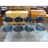 A set of four black lacquered metal framed chairs