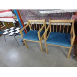 A pair of beech armchairs and a tiled top coffee table