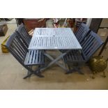 A wooden garden table and four chairs