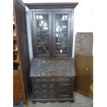 A Victorian Jacobean Revival carved oak bureau bookcase