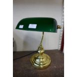 A brass students desk lamp