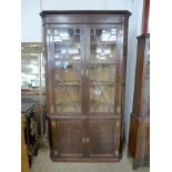 A George III mahogany freestanding corner cabinet