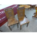 A pair of Victorian carved oak hall chairs