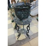 A cast metal jardiniere and stand