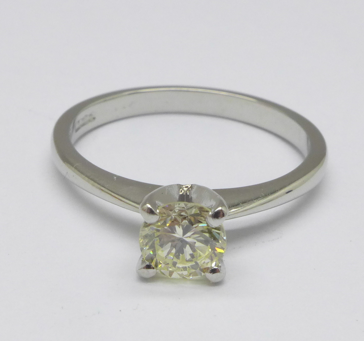 A platinum set diamond solitaire ring, 3.