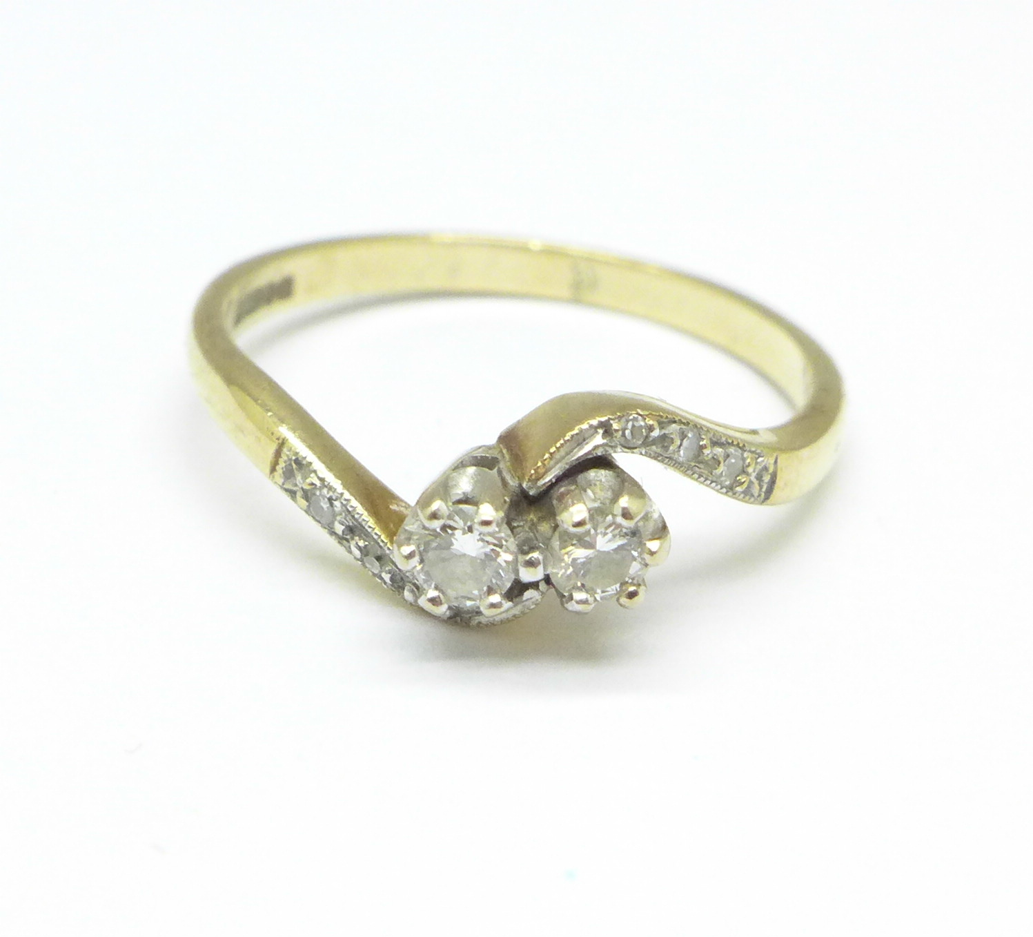 A 9ct gold, two stone diamond crossover ring with diamond shoulders, 2.