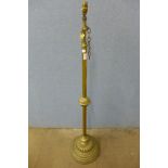 A Victorian Aesthetic Movement adjustable brass standard lamp
