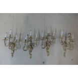 A set of four rococo style gilt metal wall lights