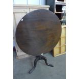 A George III mahogany circular tilt top tripod table