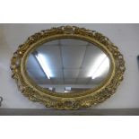 An oval gilt framed mirror