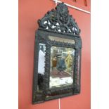 A 19th Century Baroque style carved black wood cushion framed mirror