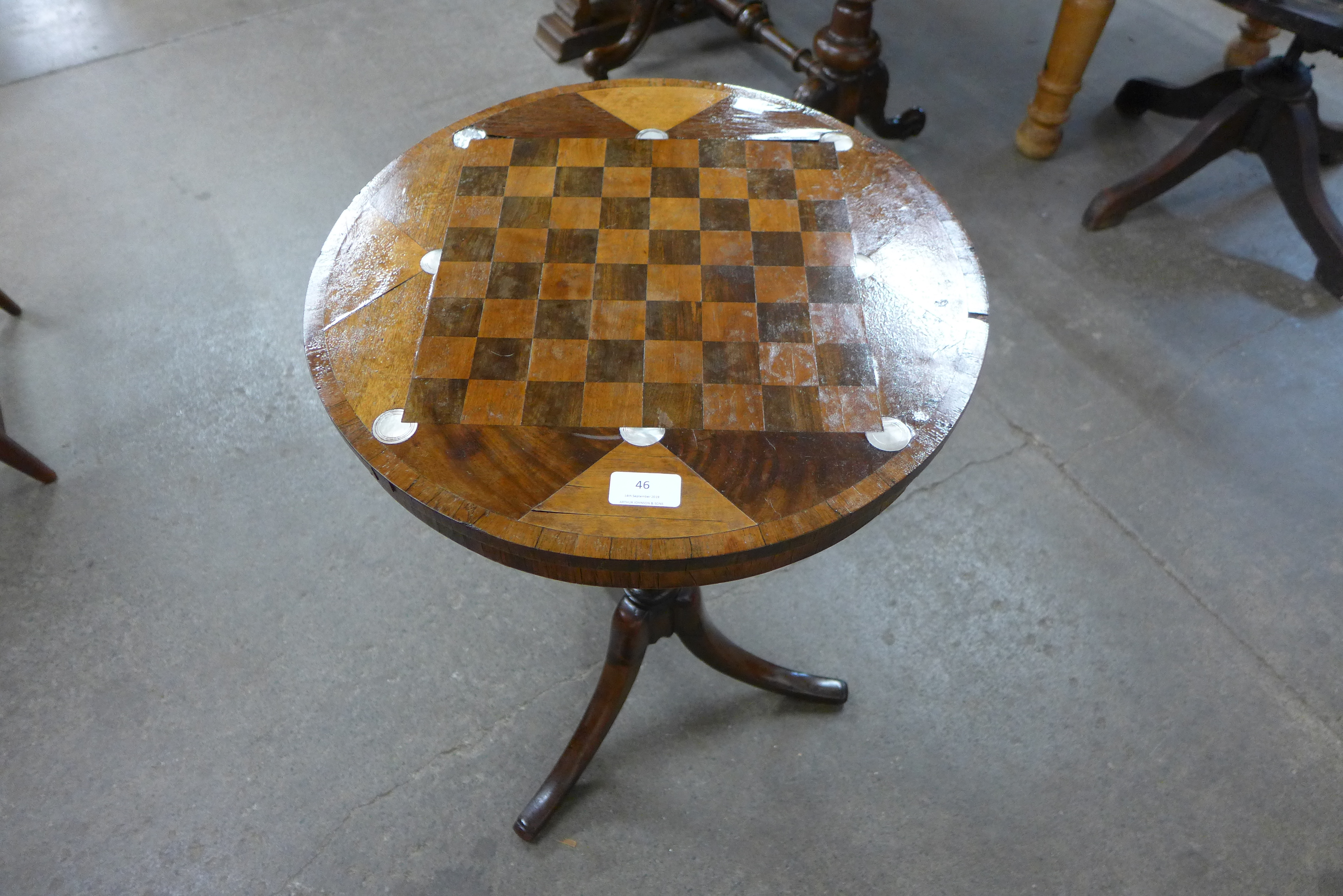 A Victorian mahogany inlaid tripod games table,